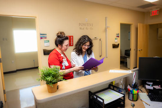 Dr. Poone Tehrani works with a colleague.