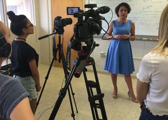 Woman in front of tv cameras