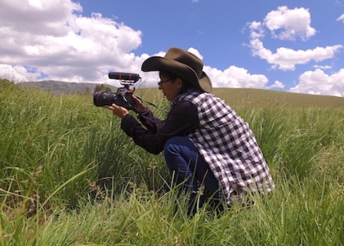 DCIM100MEDIADJI_0042.JPG Photographer in grass taking photo.