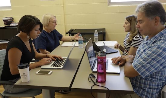 Team works at desk together