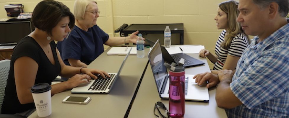 Team works at desk together